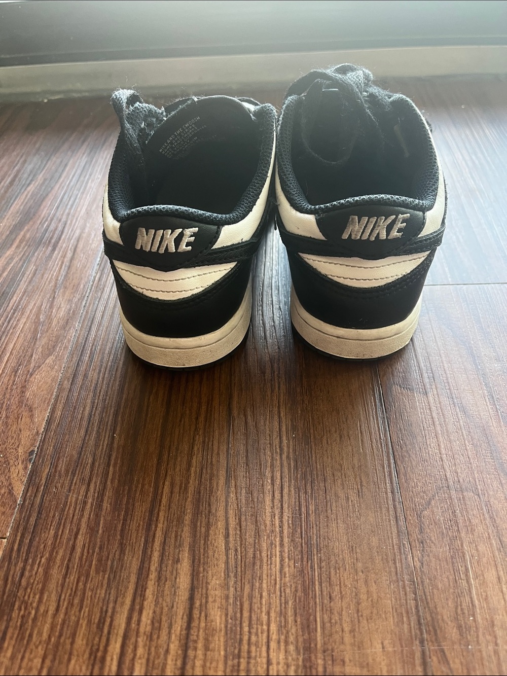 Nike Kid's Black and White Low-Top Sneakers with Contrast Swoosh